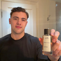 Man holding an AW Scents designer inspired perfume bottle