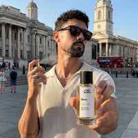 Man applying AW Scents perfume outdoors